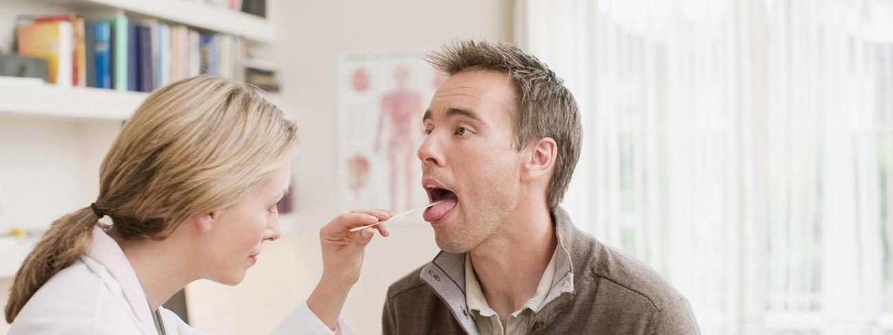 doctor checking patient's throat