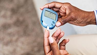 diabetes and heart disease - woman testing blood sugar
