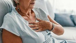 elderly woman holding chest