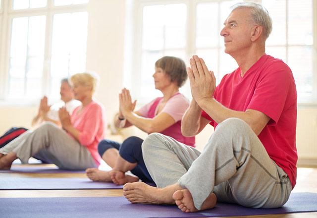 Senior adults practicing yoga.