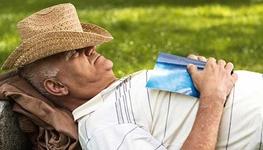 senior man with hat napping outdoors