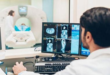 Radiologist reviewing patient scans