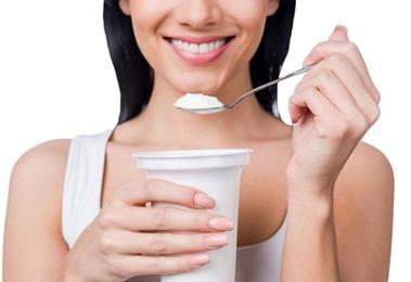 woman holding yogurt
