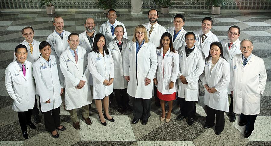 Group of doctors wearing white coats, smiling together