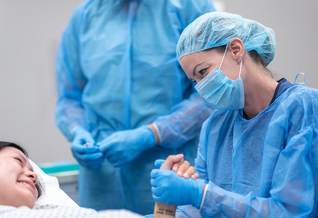 johns hopkins surgery - surgeon holding woman's hand before surgery